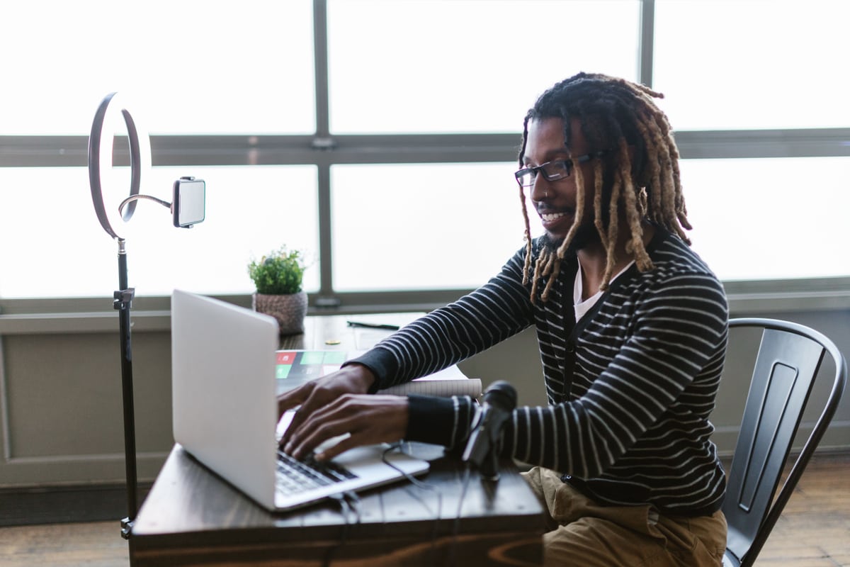 Creator editing AI video content on a laptop