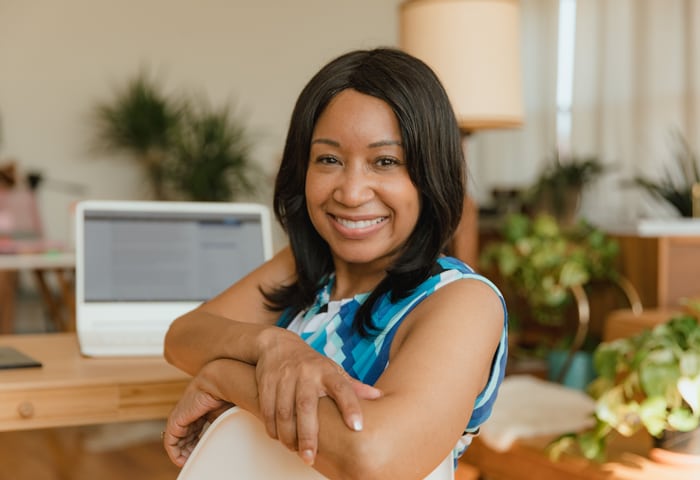 Business owner smiling while reviewing her new website
